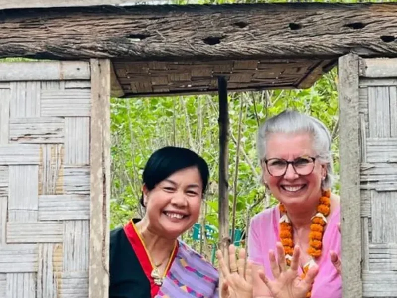 Travelers meeting local people in Laos during a cultural learning experience.