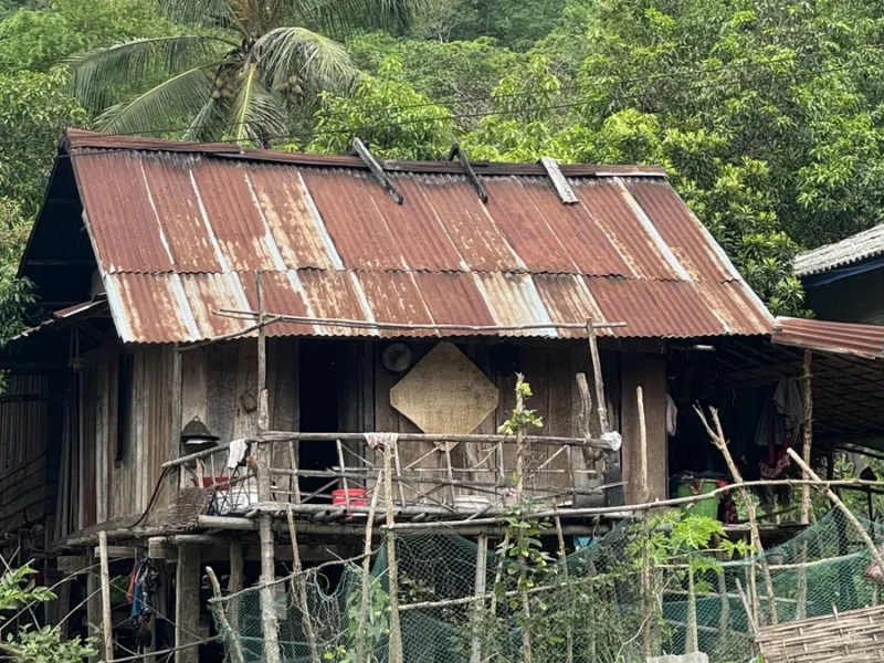 Traditional rural wooden house in northern Laos, illustrating a tribal culture journey.